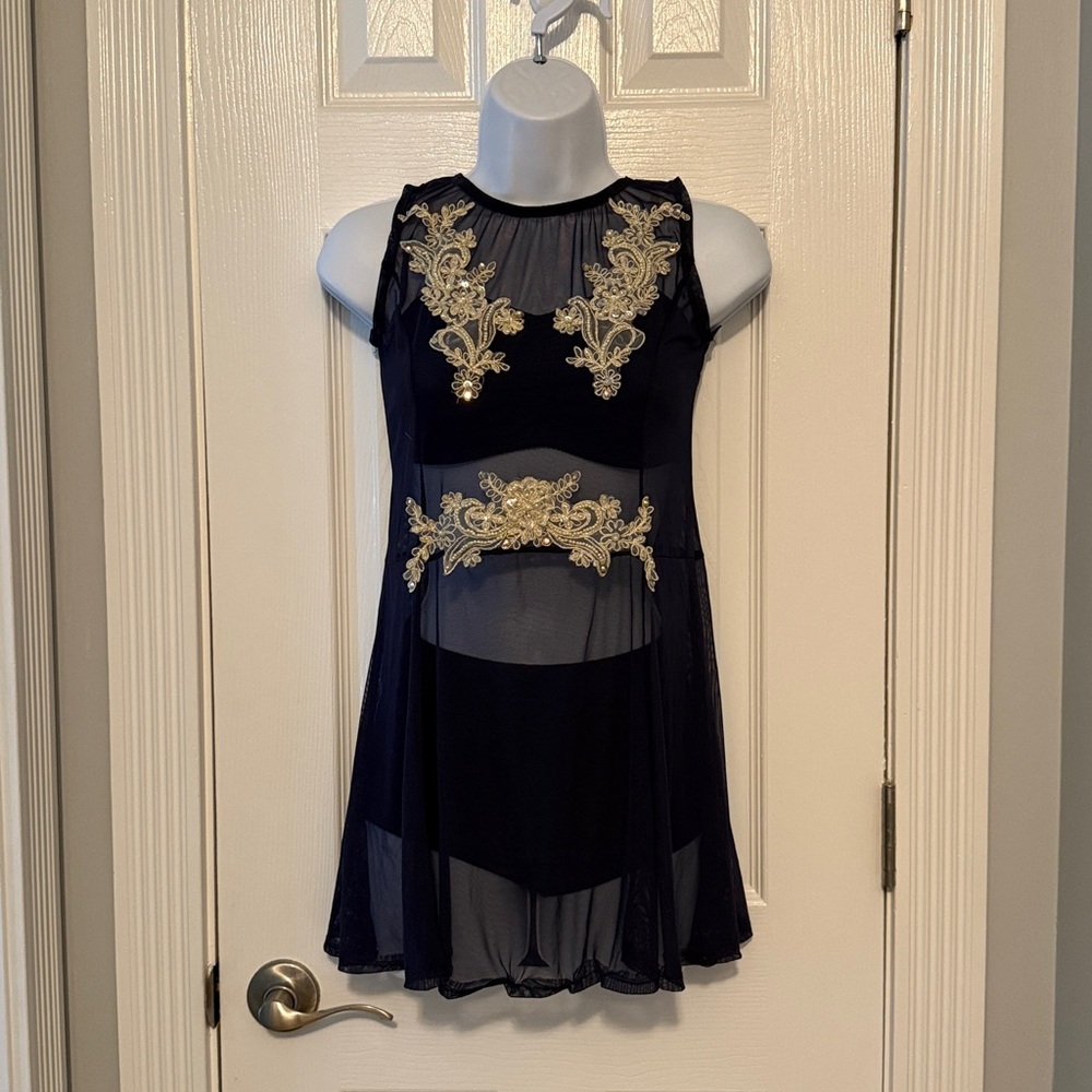 Elegant navy blue dance costume with cream colored embellishment.
